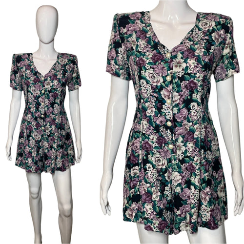 Floral romper on a mannequin against a plain background