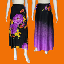 Load image into Gallery viewer, Two views of a black midi skirt displayed on a white mannequin, showing a large purple and orange floral print on the left and a purple-to-black gradient with floral print on the right.
