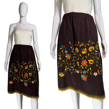Load image into Gallery viewer, Brown skirt with colorful floral embroidery on a mannequin against a white background.

