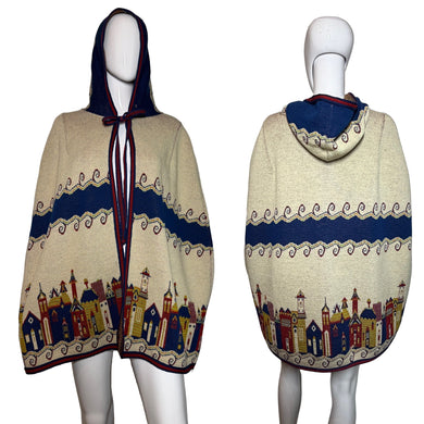 Mannequin wearing a patterned cape with a cityscape design on a plain background