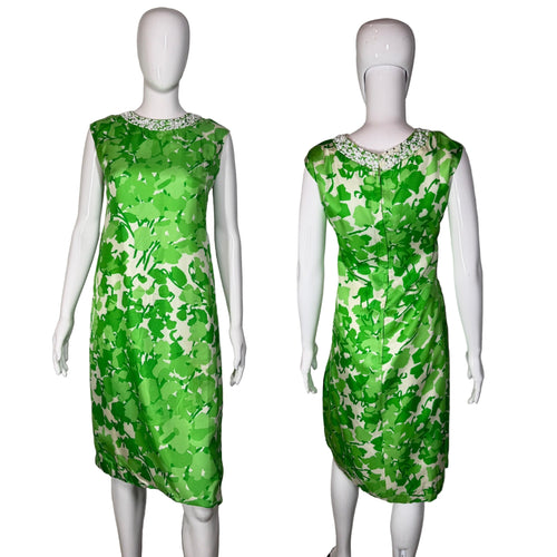 Green floral dress on a mannequin against a plain background