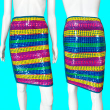Load image into Gallery viewer, A colorful striped skirt displayed on a white mannequin from the front and back, featuring horizontal bands of yellow, blue, green, and magenta sequins with a teal border.
