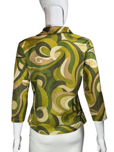 Load image into Gallery viewer, Green and beige patterned fabric draped over a white object on a gray background
