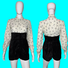 Load image into Gallery viewer, A one piece romper displayed on a white mannequin, showing both front and back views. featuring a long-sleeve button-down top with a black cat print on a white background, and high-waisted black velvet shorts.
