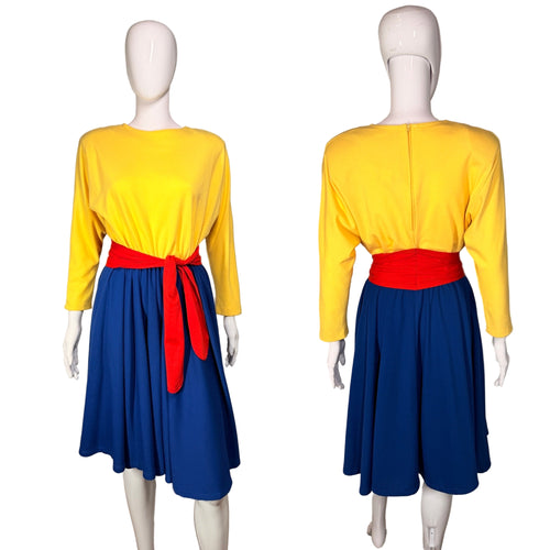 Dress with a yellow top, red belt and blue skirt on a mannequin against a neutral background