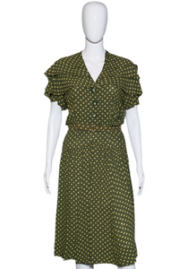 Green polka dot dress on a white mannequin against a white background