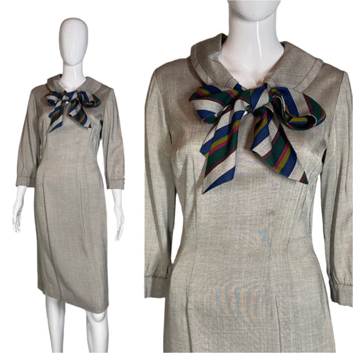 Mannequin wearing a beige dress with a colorful scarf against a plain background