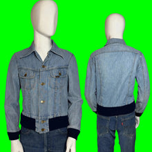 Load image into Gallery viewer, A light blue denim jacket with dark navy ribbed trim at the collar, cuffs, and hem, displayed on a white mannequin with front and back views. 
