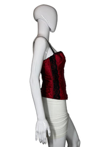 Mannequin wearing a red garment with black trim on a plain background