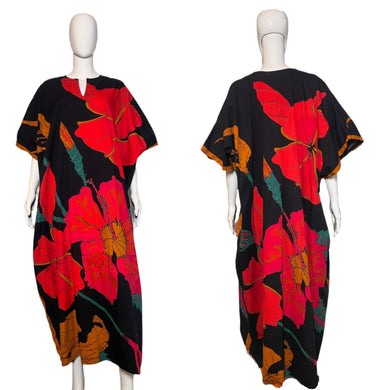 Black dress with red floral pattern on a mannequin against a white wall.