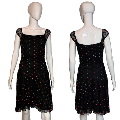 Black polka dot dress on a mannequin against a plain background