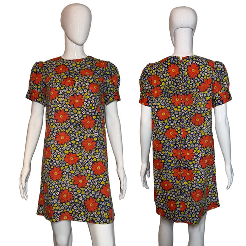 Floral dress on a mannequin against a plain background