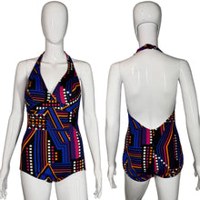 Load image into Gallery viewer, Multicolored geometric patterned swimsuit on a mannequin against a white background
