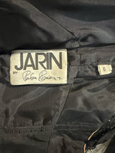 Load image into Gallery viewer, Close-up of a 'Jarin' label on a dark fabric background
