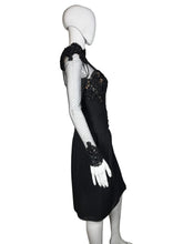 Load image into Gallery viewer, Black dress with sheer sleeves and embellishments on a mannequin against a neutral background
