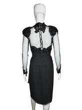 Load image into Gallery viewer, Black dress with sheer sleeves and embellishments on a mannequin against a neutral background
