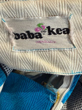 Load image into Gallery viewer, Close-up of the label with 'Baba Kea' branding on the fabric.
