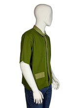Load image into Gallery viewer, Green shirt on a mannequin against a gray background
