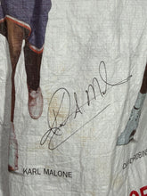 Load image into Gallery viewer, Close-up of a signature on a textured surface with 'Karl Malone' text and a discolored spot
