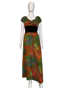 Colorful floral dress on a mannequin against a plain background