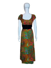 Load image into Gallery viewer, Colorful patterned dress on a mannequin against a white wall.
