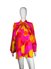 Load image into Gallery viewer, Mannequin wearing a colorful dress with pink, yellow, and orange pattern on a plain background
