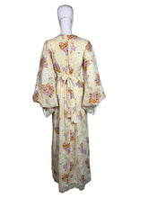 Load image into Gallery viewer, Floral dress on a mannequin against a plain background
