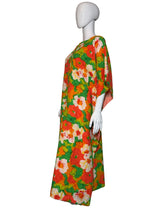 Load image into Gallery viewer, Mannequin wearing a colorful floral dress against a white wall.
