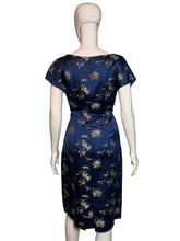 Load image into Gallery viewer, Navy blue dress with white floral pattern on a mannequin against a plain background
