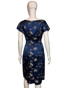 Navy blue dress with white floral pattern on a mannequin against a plain background