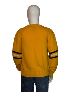 Yellow sweater with black and white stripes on a mannequin against a plain background