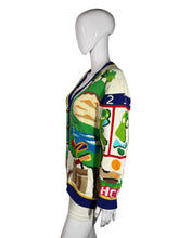 Load image into Gallery viewer, Colorful sweater with golf-themed design on a mannequin against a gray background
