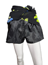 Load image into Gallery viewer, Black skirt with blue and green floral pattern showing the shorts underneath on a mannequin against a plain background
