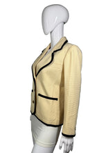 Load image into Gallery viewer, Cream jacket with black trim on a mannequin against a gray background
