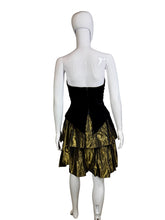 Load image into Gallery viewer, Mannequin wearing a black and gold dress against a plain wall.
