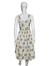 Load image into Gallery viewer, Mannequin wearing a floral dress against a plain wall.
