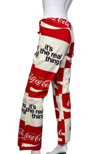Load image into Gallery viewer, Mannequin wearing red and white Coca-Cola pants 
