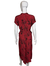 Load image into Gallery viewer, Red patterned garment on a mannequin against a white background
