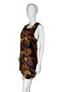 Mannequin wearing a patterned dress with a plain background
