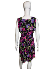 Load image into Gallery viewer, Black romper with colorful floral pattern on a mannequin against a white background

