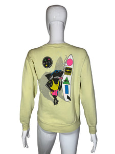 Light yellow sweatshirt with colorful graphic design on a mannequin against a gray background