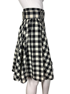 Black and white checkered skirt on a mannequin against a neutral background