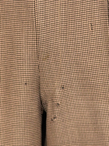 Close-up of moth holes on pants