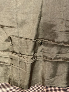 Close-up of damage on the back of the vest