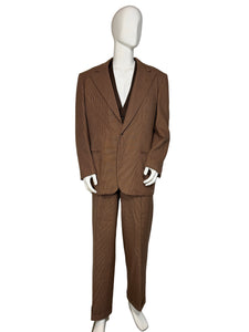 Brown suit on a mannequin against a white wall