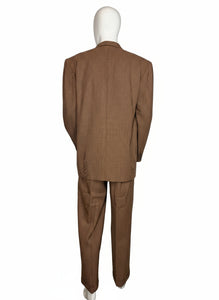 Brown suit on a mannequin against a white wall.