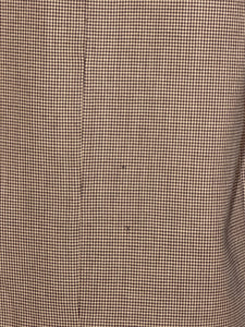 Close-up of moth holes on jacket