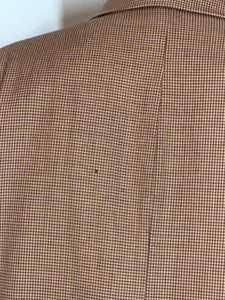 Close-up of moth hole on the back of the jacket