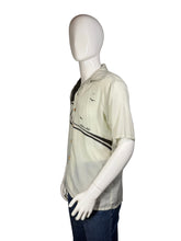 Load image into Gallery viewer, Mannequin wearing a light-colored shirt with a design on a white background
