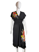 Load image into Gallery viewer, Black dress with floral applique on a mannequin against a neutral background
